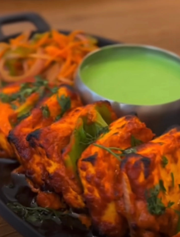 Paneer Tikka fresh cheese grilled in traditional charcoal served with green pudina chutney